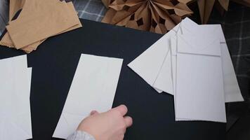 Master class of making craft paper snowflakes for conscientious Christmas decor. Sustainable celebration minimal responsible DIY holiday project. Step by step instruction video