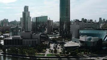 Daytime landscape shot from a helicopter. Stock footage. A bright view of a huge city with high-rise new buildings, offices located next to a pond and parks. video