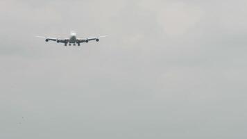 Widebody airplane approaching for landing. Aircraft in the sky, front view video
