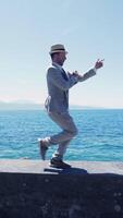 A Very Stylish Man Running Energetically by the Beautiful Ocean While Dressed in a Smart Suit video