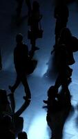 Silhouettes of various people in motion at a bustling and busy venue or gathering place video
