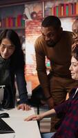 Vertical Overjoyed multiethnic startup team celebrating high valuation on stock exchange, raising money. Happy tech business entrepreneurs securing angel investments, becoming unicorn company, camera A video