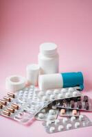 A striking array of colorful pills and bottles is arranged against a bright pink background, emphasizing their vital role in todays healthcare and diverse treatment options photo