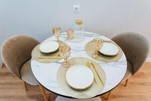 A beautifully set dining table, where carefully arranged plates, glasses, and utensils sit, creates a warm and inviting atmosphere perfect for savoring a delicious meal with loved ones photo