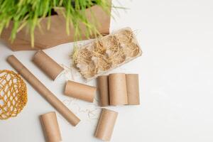 Household waste of cardboard and paper rollers lie on a white table photo