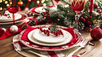Festive christmas table setting with red and white decor and evergreen accents photo