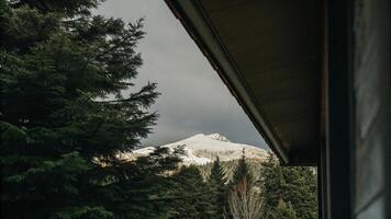 A view of a snowy mountain from a window photo