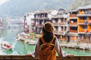 Young female tourist looking at the beautiful landscape of Feng Huang Ancient Town photo