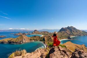 Young tourist enjoying the beautiful landscape at Padar island in Komodo National Park, Indonesia photo