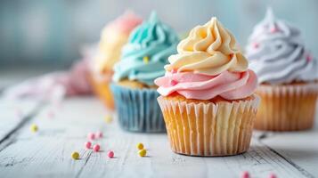 Colorful cupcakes on a wooden table photo
