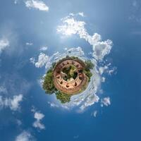 A small planet with a building in the middle photo