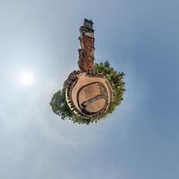 A small planet with a clock tower in the middle photo