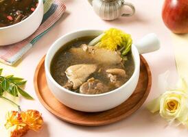 Healthy Sesame Oil Chicken Soup with cabbage served in bowl on wooden tray side view of taiwan hot soup photo