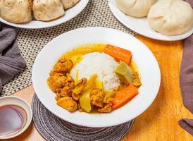 Nanyang Chicken Curry Rice and Steamed Buns with sauce served in plate isolated napkin side view of taiwan dim sum food photo
