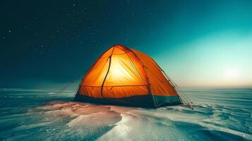A tent set up in the snow at night, with a breathtaking starry sky in the background, creating a peaceful and adventurous winter camping scene photo