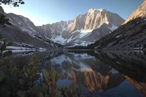 Snowy mountains of the Snowy Range reflect in the crystal-clear waters of a lake, creating a mesmerizing landscape. Perfect for imagery about nature and mountains photo