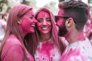 A dynamic scene from the Color Run event in Stockholm, with participants covered in bright, colorful powders as they run through the city, celebrating fitness and fun photo