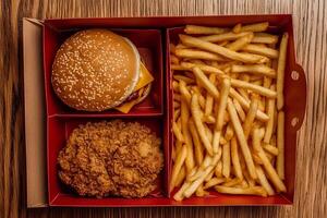 A delicious fast food set in a box a burger, French fries, and chicken nuggets. The perfect choice for a quick snack or lunch on the go, creating an atmosphere of convenience and enjoyment of food photo