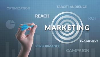 Hand aiming at a target labeled 'Marketing,' surrounded by words like target audience, reach, campaign, ROI, performance, and optimization, symbolizing strategic and precise marketing efforts photo