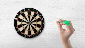 Dartboard with scoring sections. Hand holding a dart, perfect for precision, focus, and competitive concepts photo