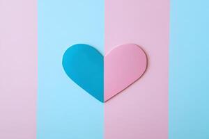 A blue and pink heart cutout is centrally placed against alternating pastel colored stripes, creating a visually appealing and playful composition. photo