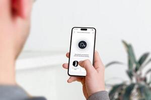 Smartphone screen with an online shop voice search feature active. A microphone icon is displayed as the user searches for smartwatches by voice photo