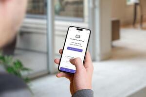 Man holding a smartphone with a banking app confirmation screen showing the purchase amount and an 'Approve Payment' button photo