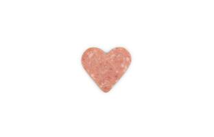 Creative composition for Valentine's Day with slice of sausage cut in heart shape and isolated on white background. Top view. photo