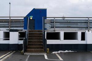 Steps leading to a blue building at a parking structure photo