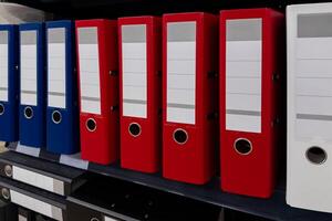Office organization with colorful file folders on a shelf photo