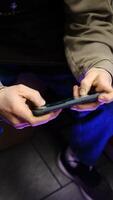 Young man playing mobile game with fast finger movements and colorful pulsating hand lights, dynamic gameplay, close up phone screen, digital entertainment, gaming action, energetic gaming session. photo