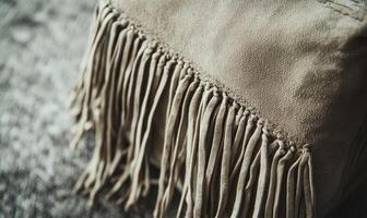 A tan object with fringes on it photo