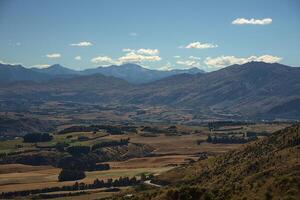 A view of a valley with mountains in the background photo