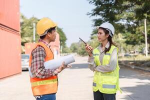 Logistics engineering team engaging in detailed discussions over challenges using a walkie-talkie at a construction site photo
