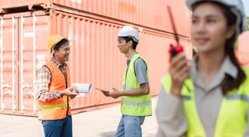 Construction team engaging in discussion with blueprints and communication tools on-site photo