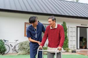 Nurse engaging with elderly man using walker, fostering connection in a nurturing garden environment photo