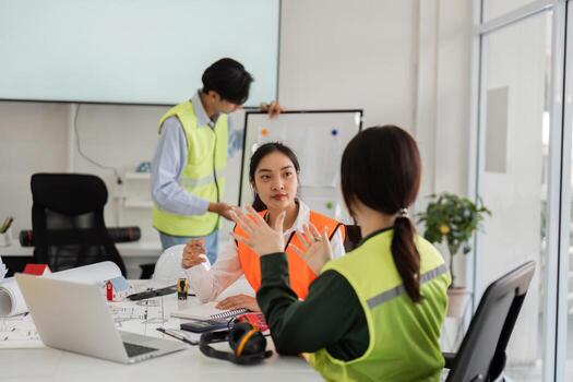 Collaborative construction discussion. architect and engineer strategizing over plans in a modern office setting photo