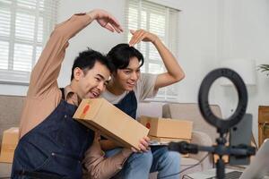 Joyful social media marketers making fun gestures during a product showcase live stream in their home office photo