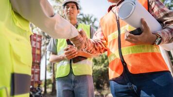 Engineers sealing a deal with a handshake construction professionals collaborating on a project photo