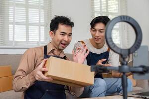 Cheerful social media marketers sharing product unboxing during a live stream in their cozy home office photo