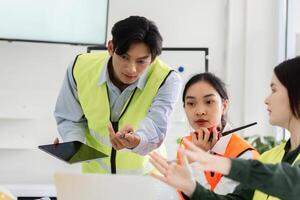 Construction manager leading project discussion with visuals and instructions in a meeting photo