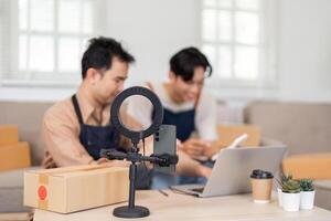 Entrepreneurs setting up live stream for unboxing in their home office photo