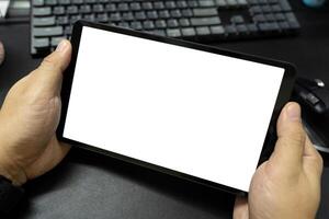 Blank screen tablet on desk. Digital tablet with isolated screen in male hands. digital tablet with empty display. photo
