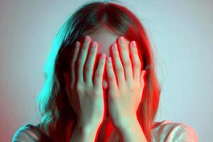 individual covers their face with both hands, conveying a sense of distress or emotional turbulence, depicted in a close-up shot focusing on the hands and partial expression. photo