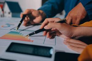 Two people are working on a piece of paper with a graph on it photo