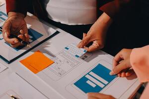 A person is working on a mobile app on a table photo