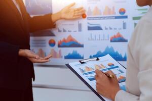 Business people discussing business data on a board photo
