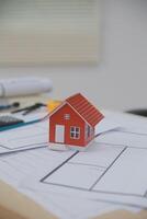 A small house is sitting on top of a desk photo