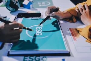 People working on a document with the esg logo photo