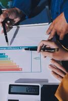 A man and woman are working on a paper with a graph on it photo